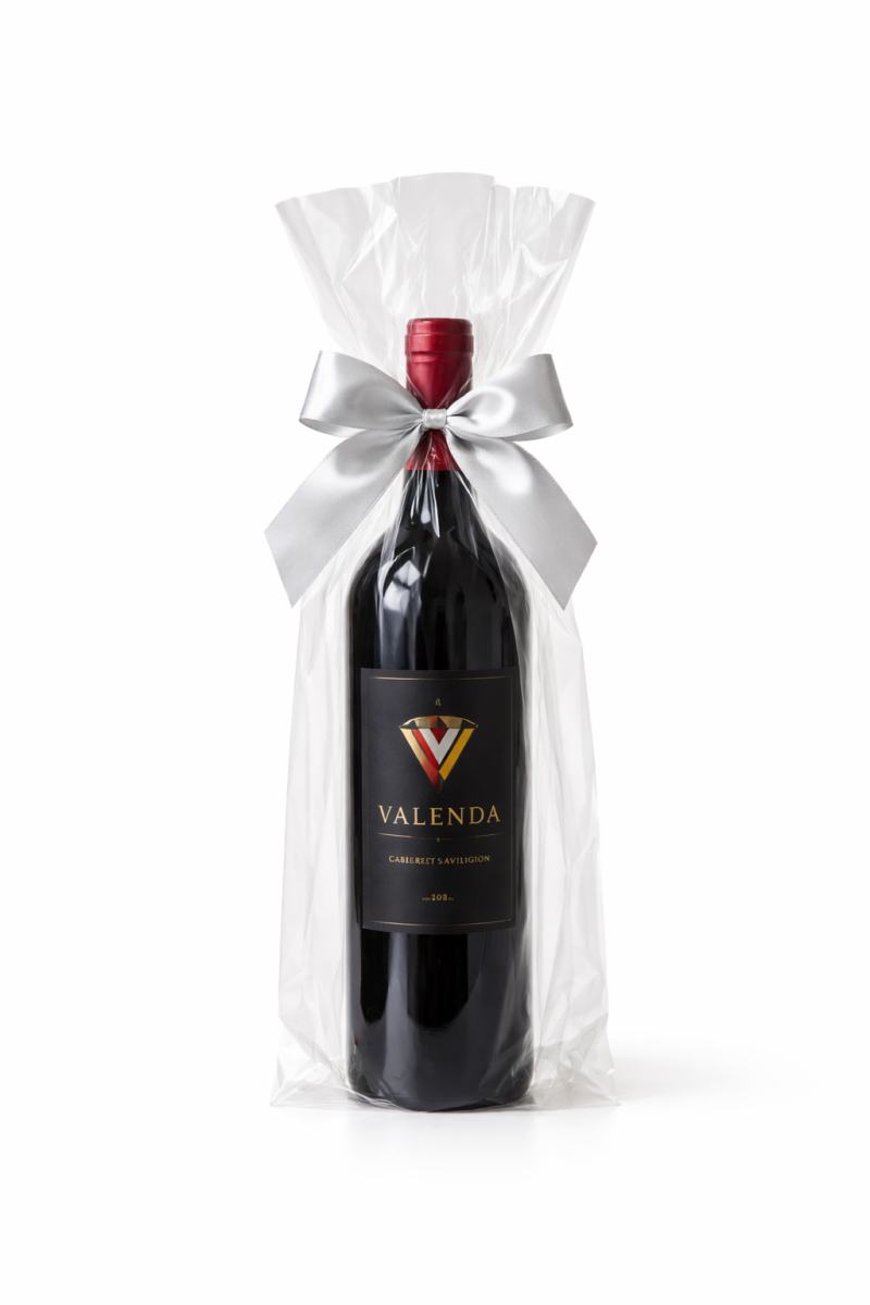 Red wine bottle wrapped in clear cello wine bag with ribbon