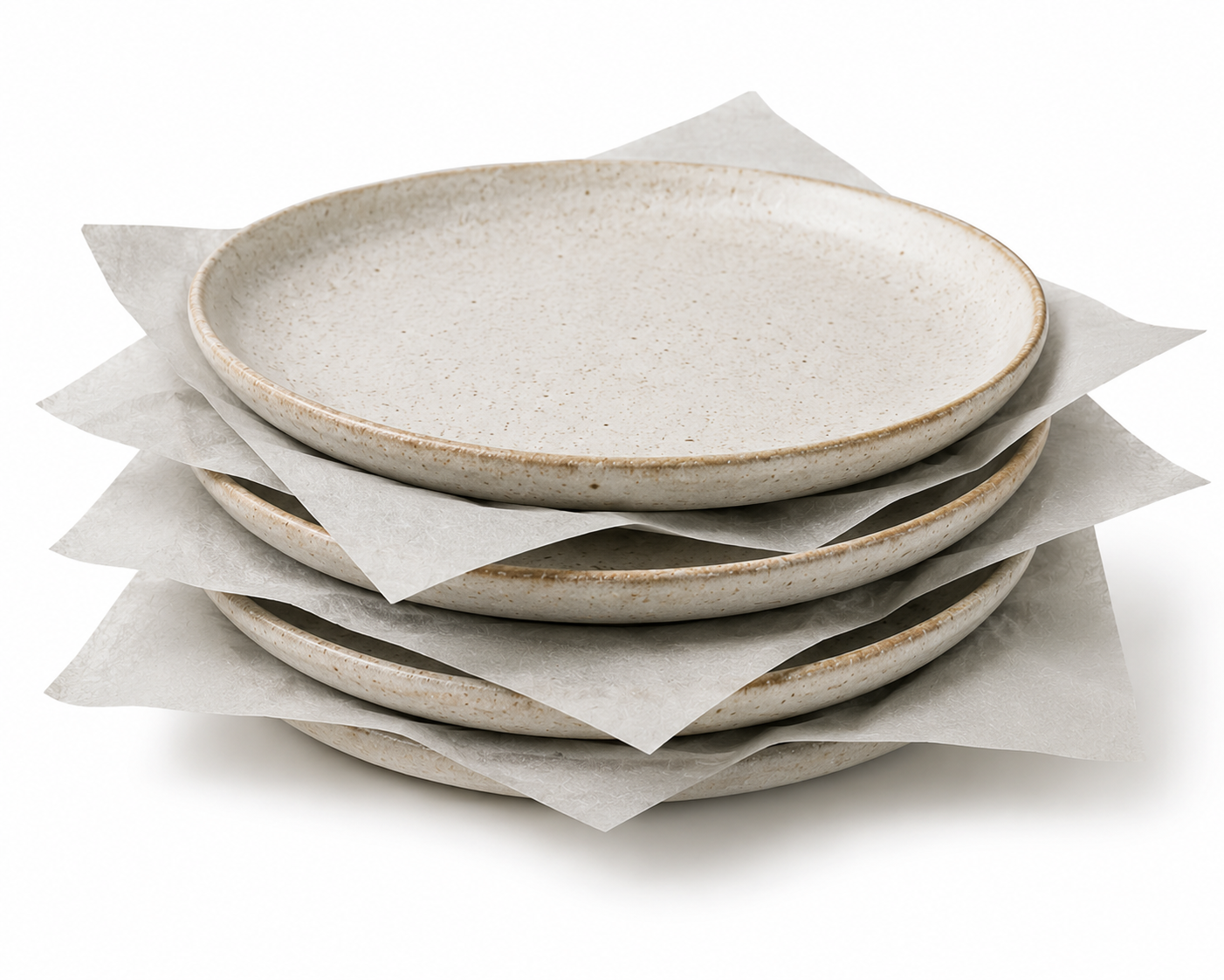 Stack of ceramic plates separated and wrapped with recycled tissue paper